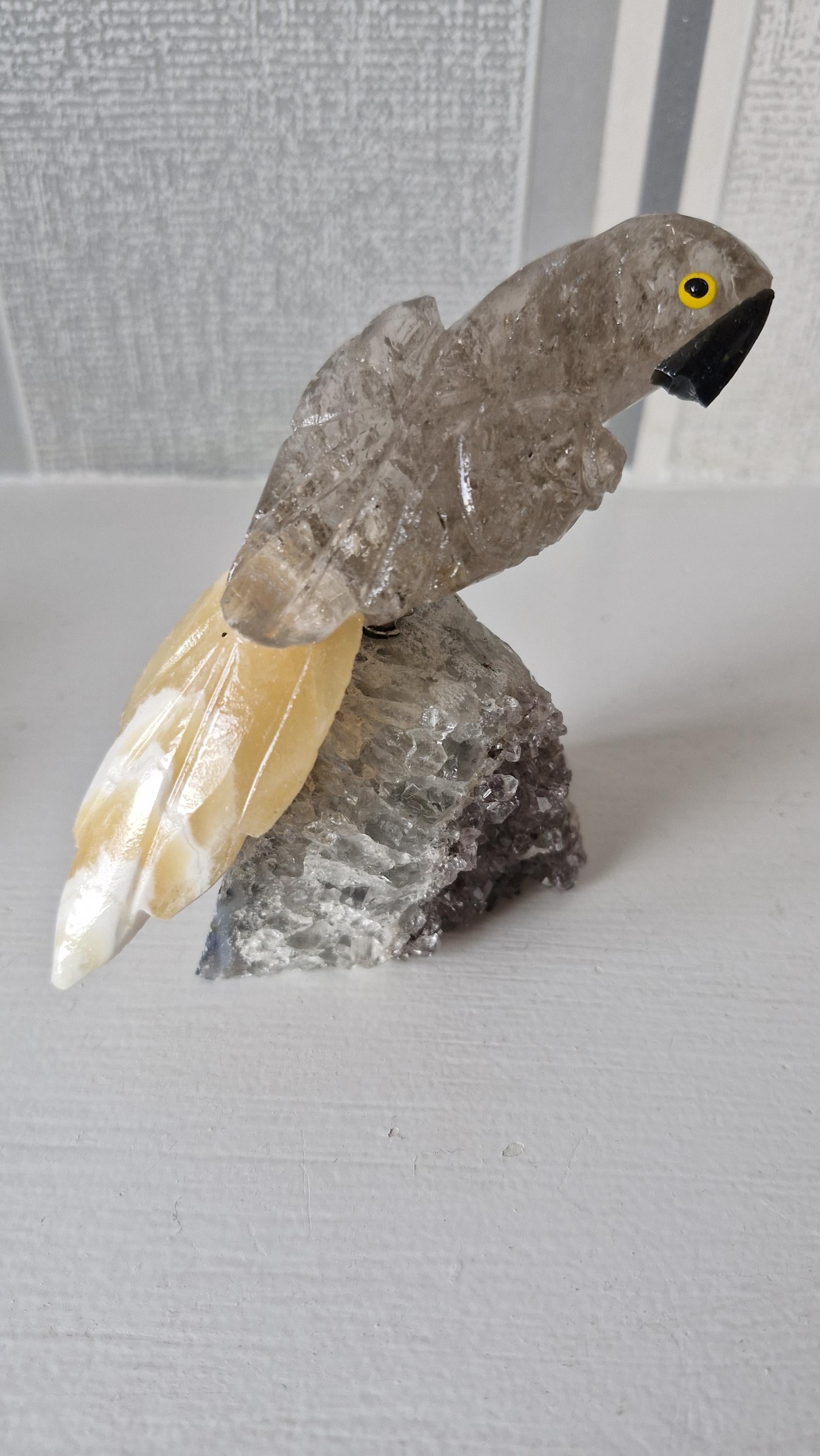 Hand carved gemstone/ crystal birds of Paradise. Bird detachable and has a Amethyst base.