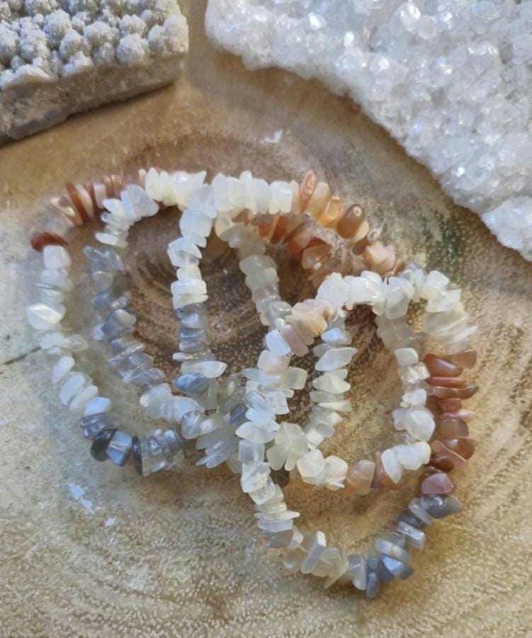 Variety of Natural Chipped Crystal Bracelets. Each one has a stretchy adjustable band.
