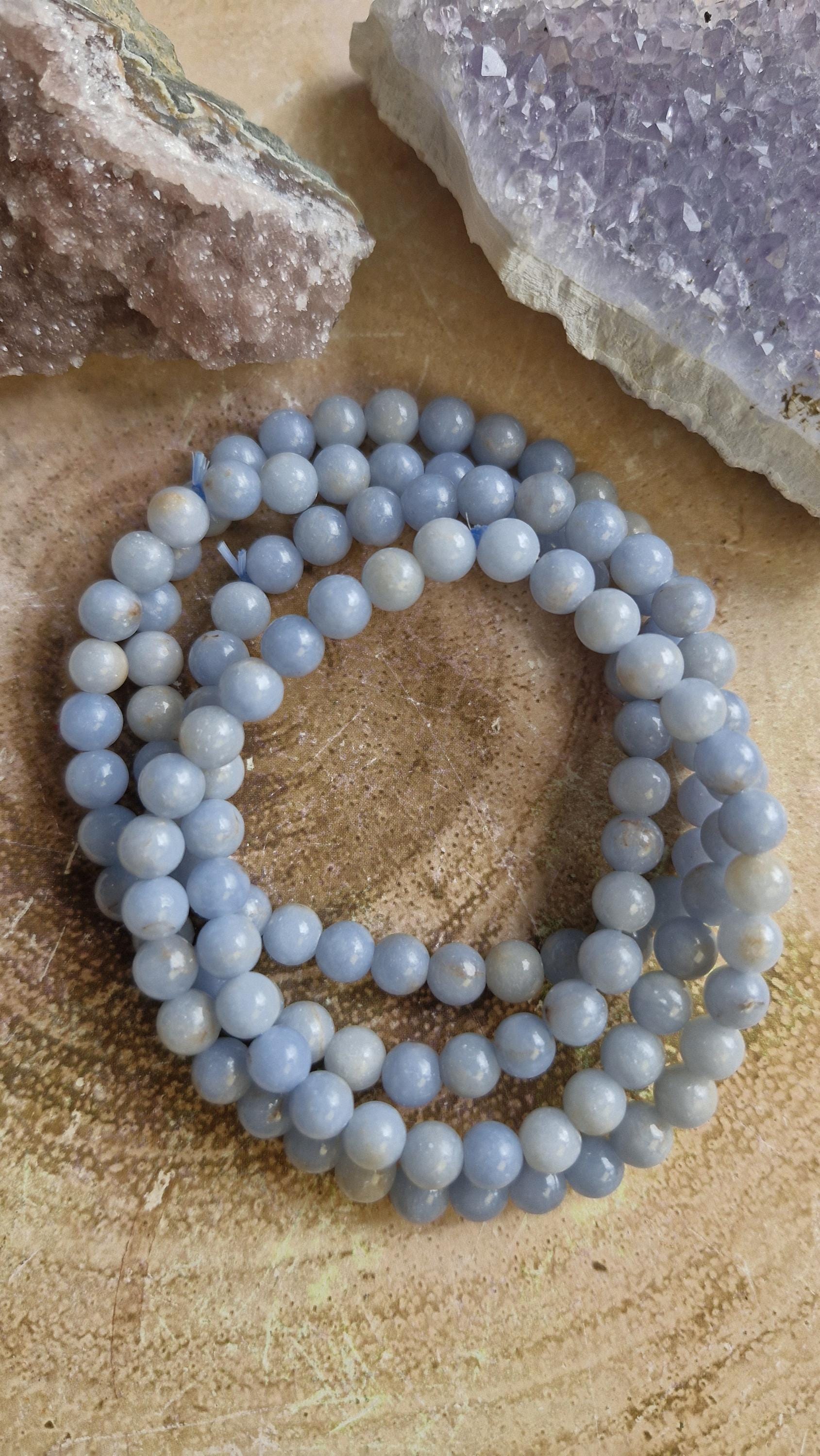 Natural Angelite and Red Jasper crystal bracelets with a silver moon charm.